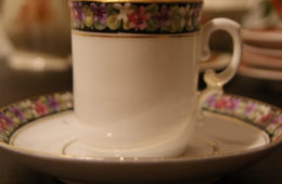 Porsgrund cup with saucer flowers on black background