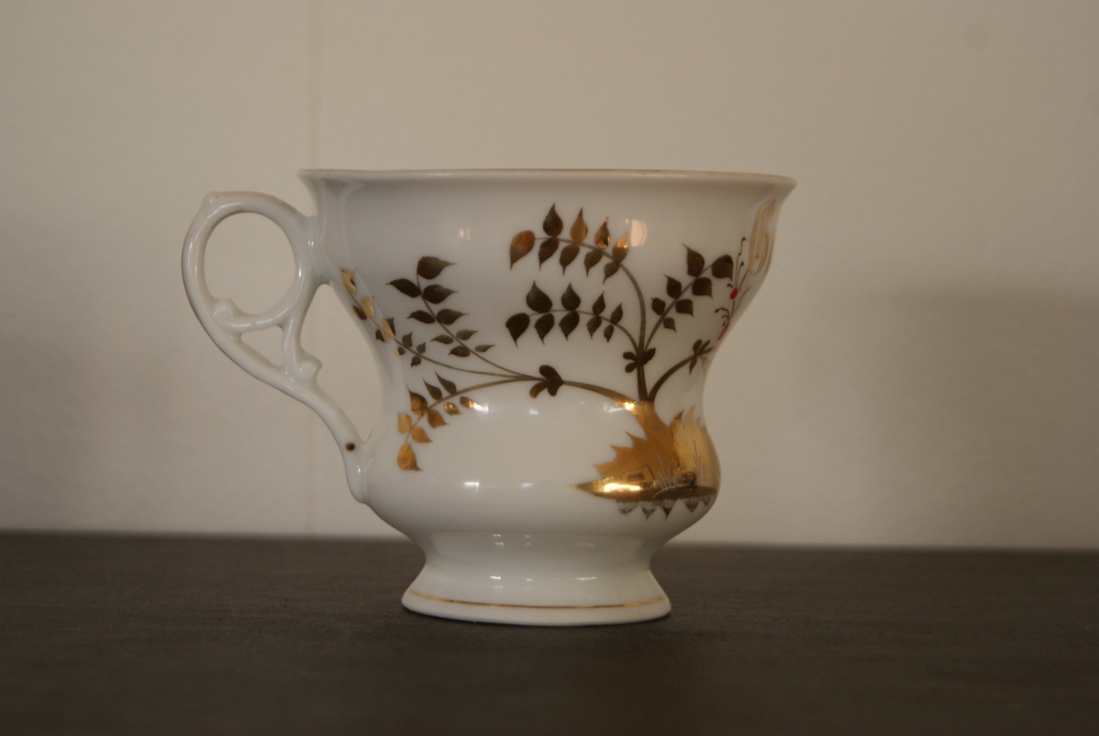 Porsgrund cup with golden decor small flowers and "Gratulerer" inscription
