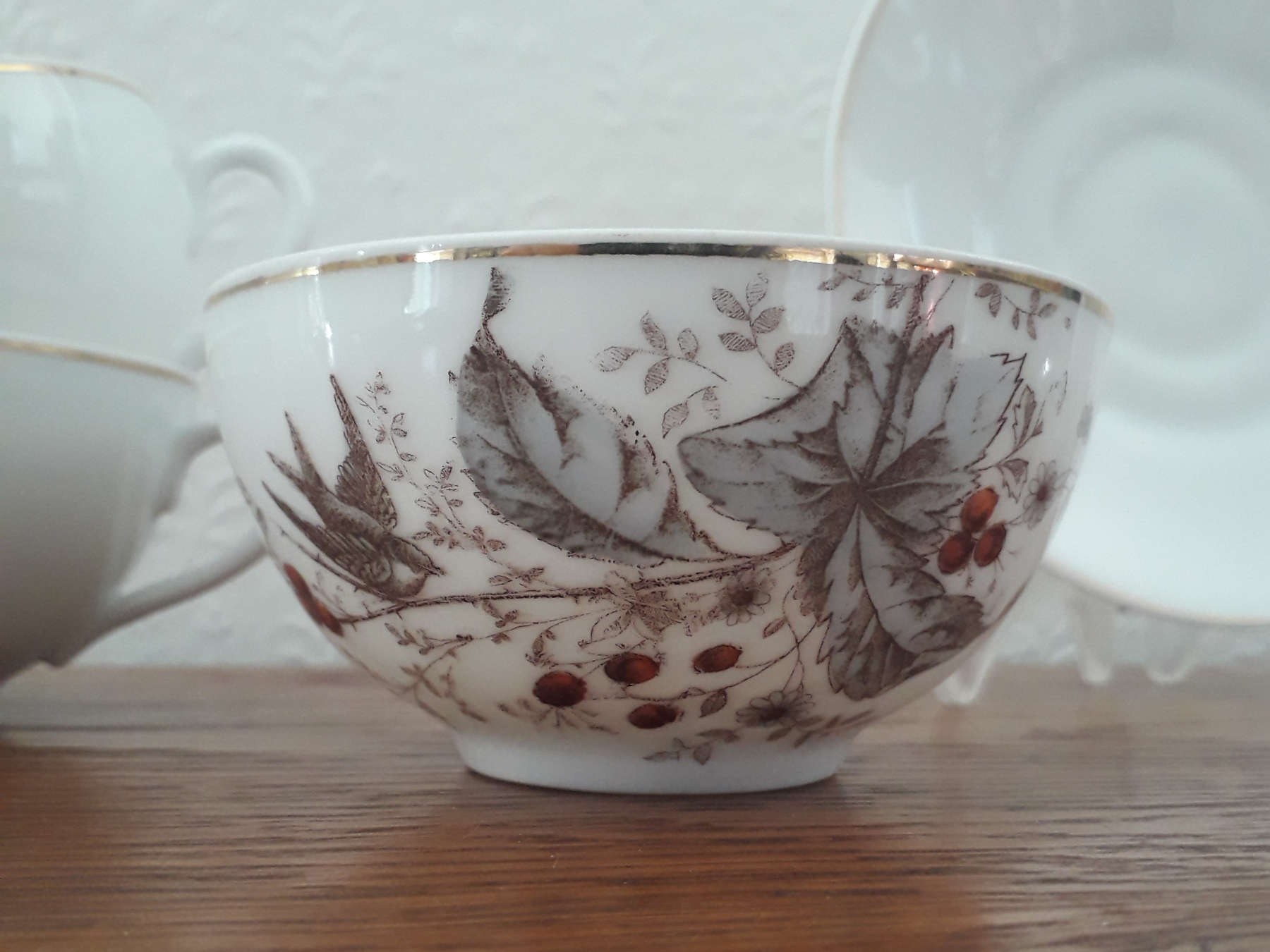 Porsgrund chocolate cup with saucer with bird on rowan. Leaves, flowers and red fruits.