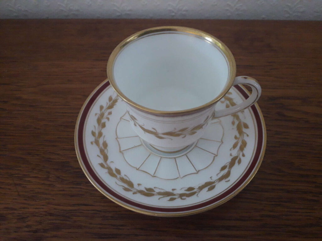 Copenhagen Bing & Grøndahl cup with saucer with golden decor and red band